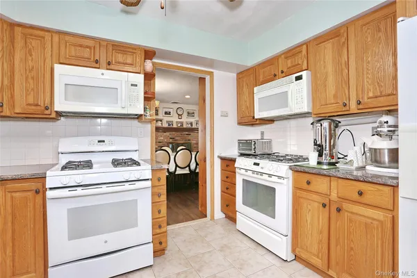 a kitchen with cabinets stainless steel appliances and a sink