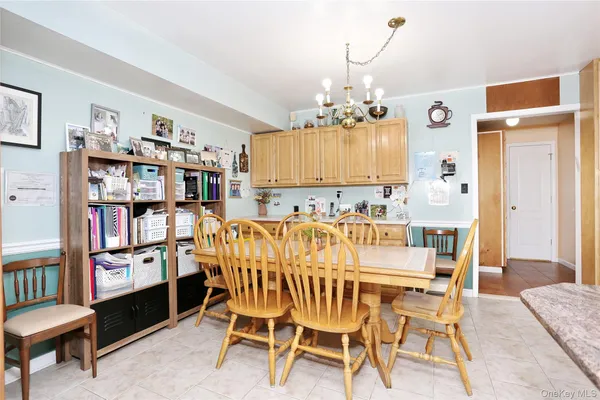 a view of a dining room with furniture and chandelier