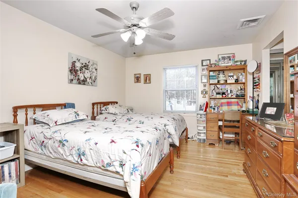 a bed sitting in a bedroom and a large window