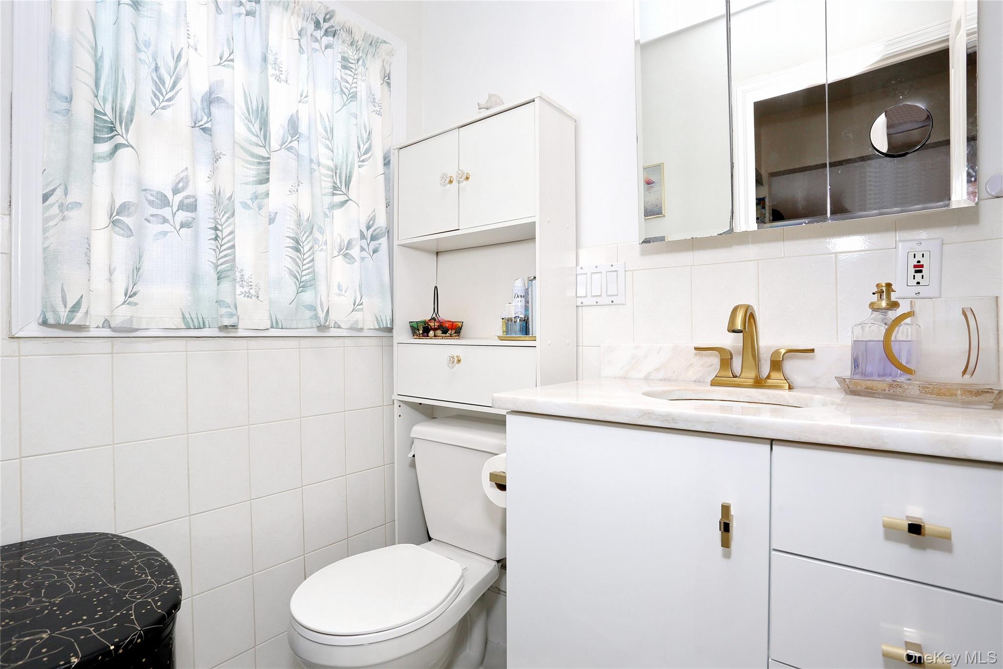277 Saddle River Road Airmont, NY 10952 - Photo 20 of 25 a bathroom with a sink a toilet and mirror