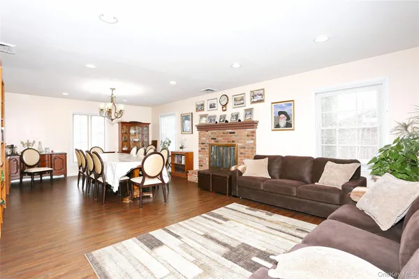 a living room with furniture wooden floor and a table