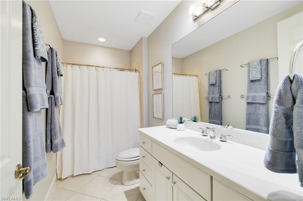 19670 Marino Lake Circle, Unit 2502 Miromar Lakes, FL 33913 - Photo 12 of 40 a bathroom with a double vanity sink toilet and shower