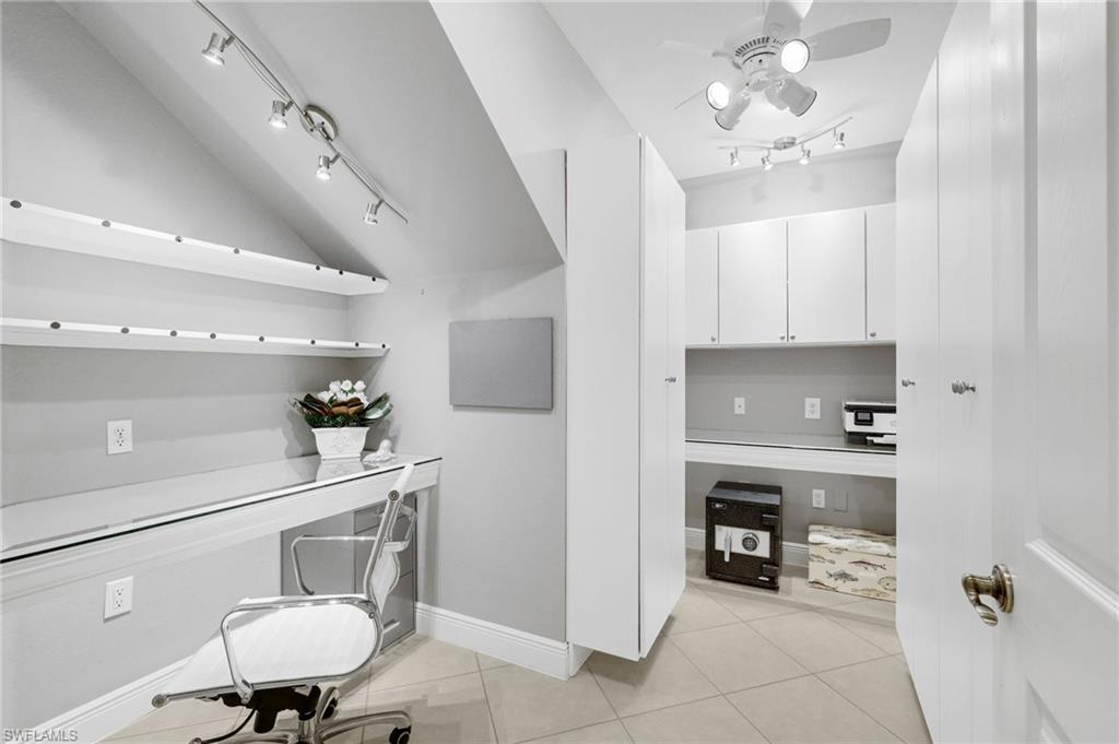 19670 Marino Lake Circle, Unit 2502 Miromar Lakes, FL 33913 - Photo 15 of 40 a kitchen with cabinets and chairs