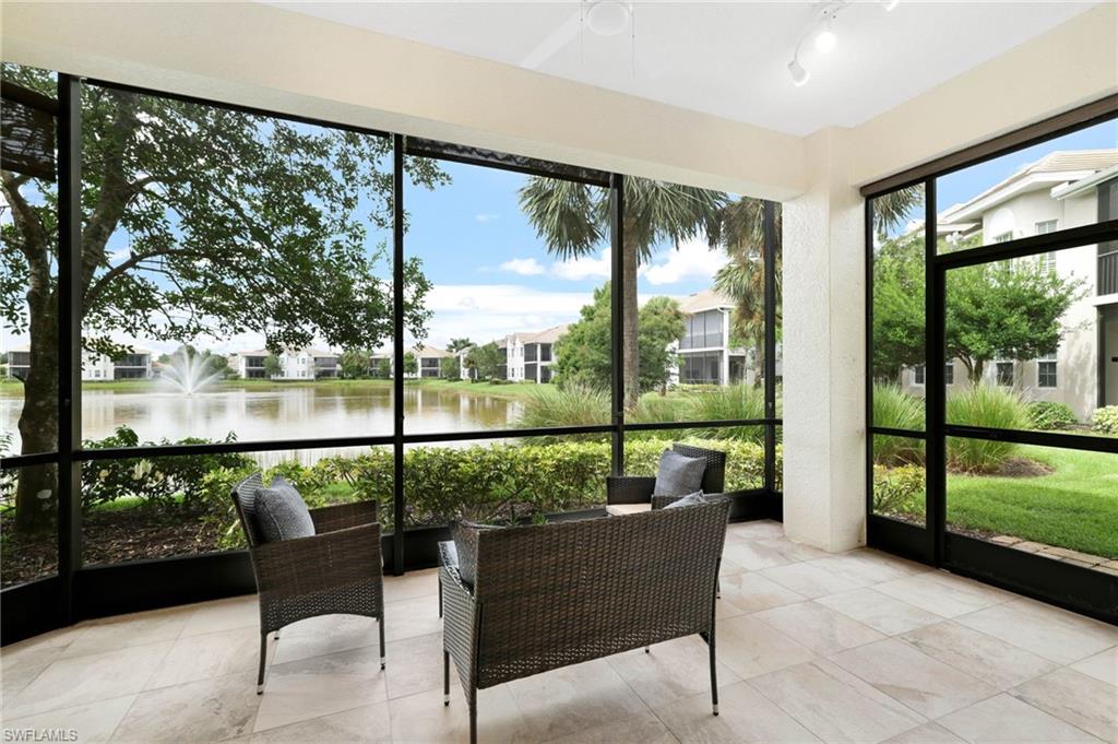 19670 Marino Lake Circle, Unit 2502 Miromar Lakes, FL 33913 - Photo 16 of 40 a balcony with wooden floor and outdoor view