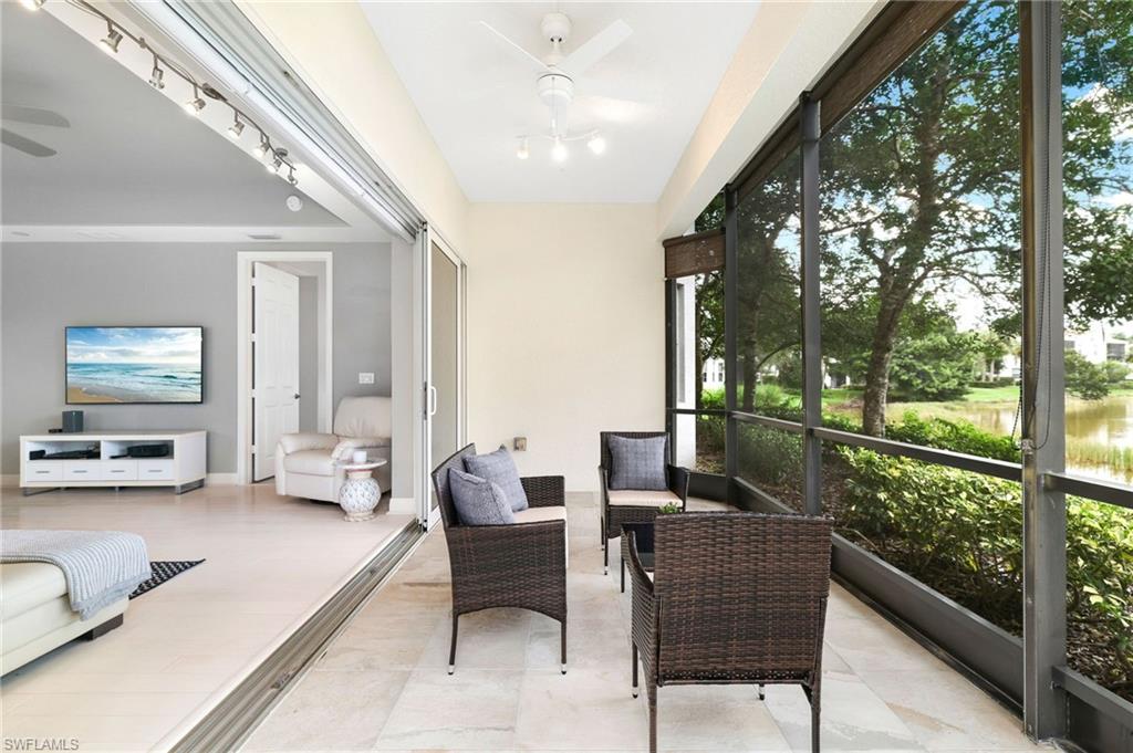 19670 Marino Lake Circle, Unit 2502 Miromar Lakes, FL 33913 - Photo 17 of 40 a living room with furniture and a floor to ceiling window
