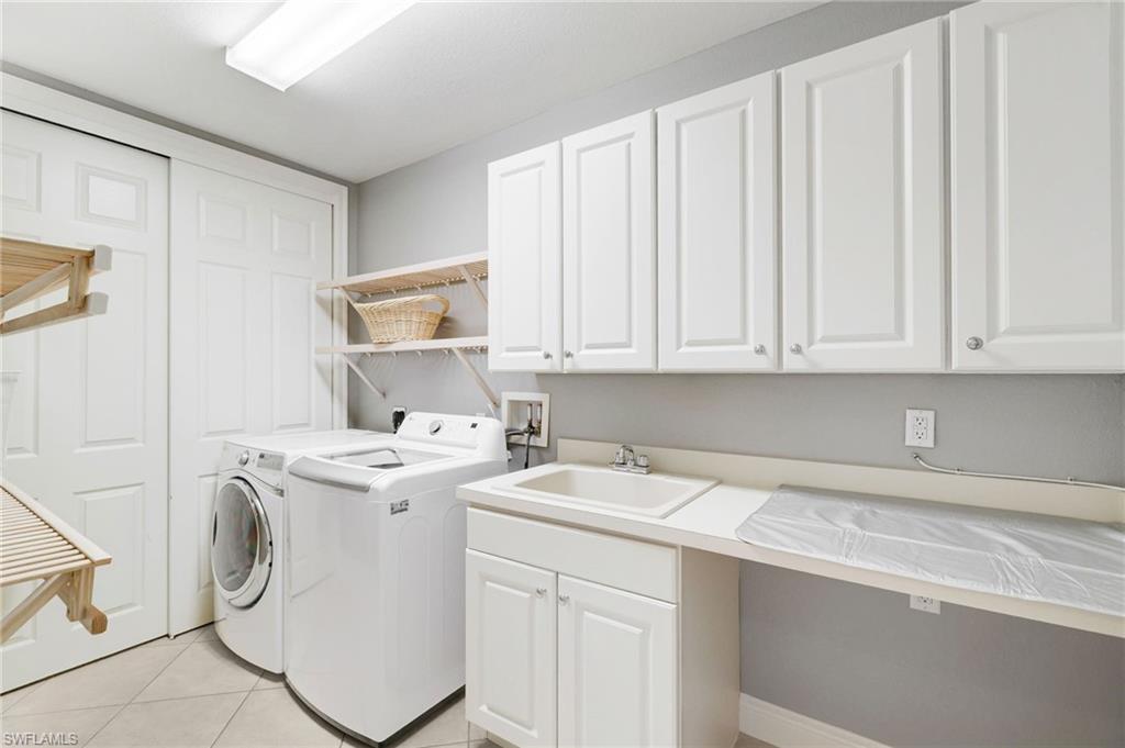 19670 Marino Lake Circle, Unit 2502 Miromar Lakes, FL 33913 - Photo 19 of 40 a utility room with dryer and washer