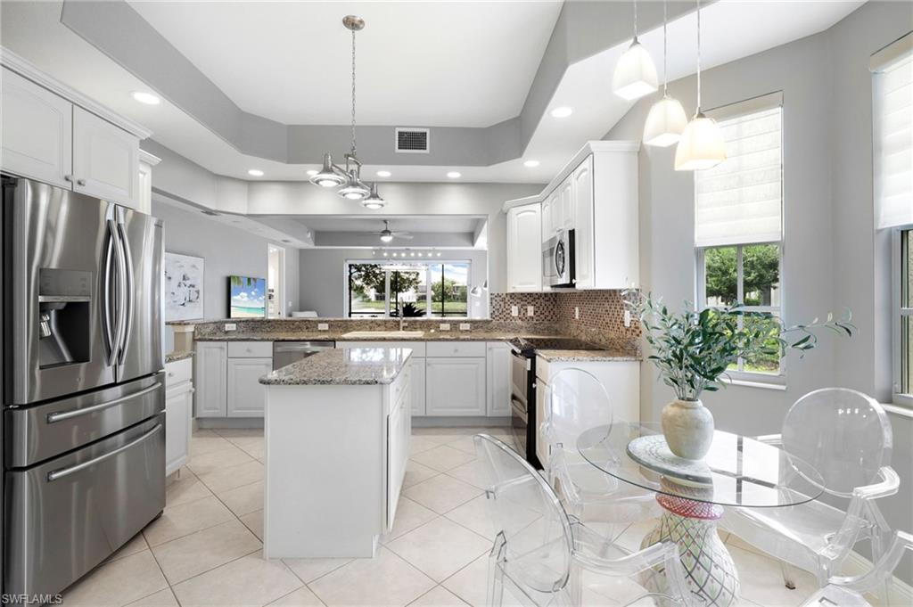 19670 Marino Lake Circle, Unit 2502 Miromar Lakes, FL 33913 - Photo 2 of 40 a kitchen with a sink and refrigerator