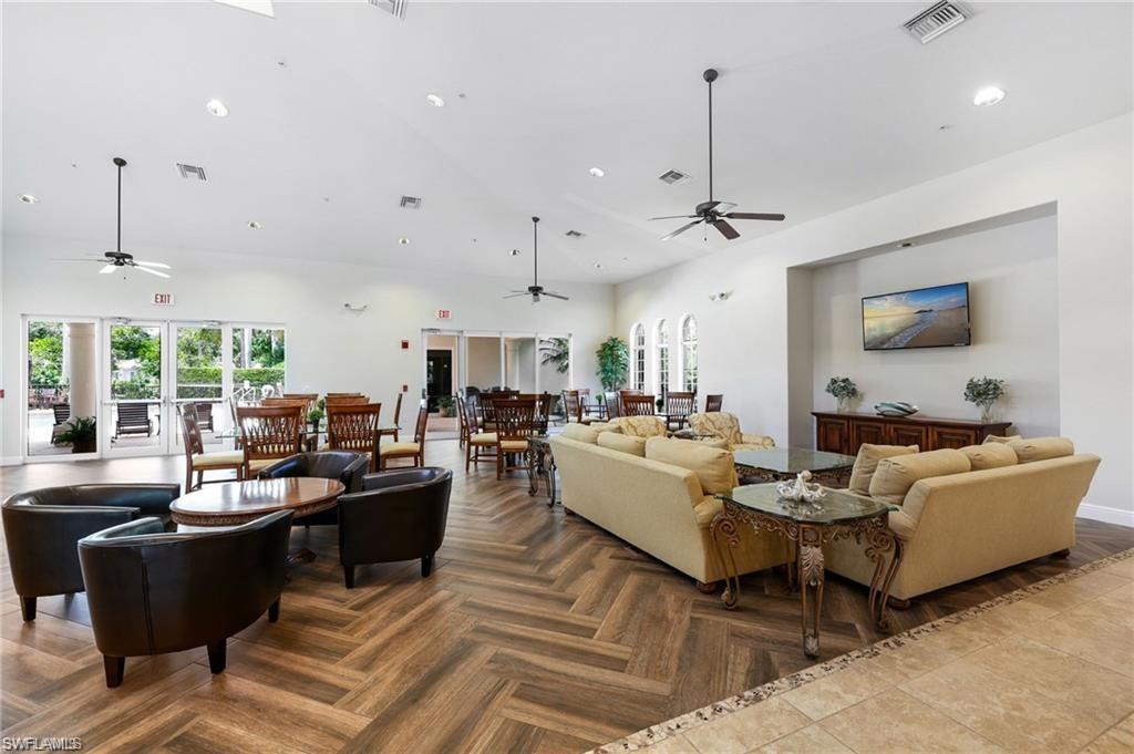 19670 Marino Lake Circle, Unit 2502 Miromar Lakes, FL 33913 - Photo 23 of 40 a living room with furniture kitchen view and a large window