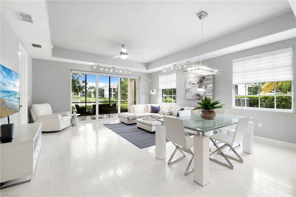 19670 Marino Lake Circle, Unit 2502 Miromar Lakes, FL 33913 - Photo 4 of 40 a living room with furniture and a large window