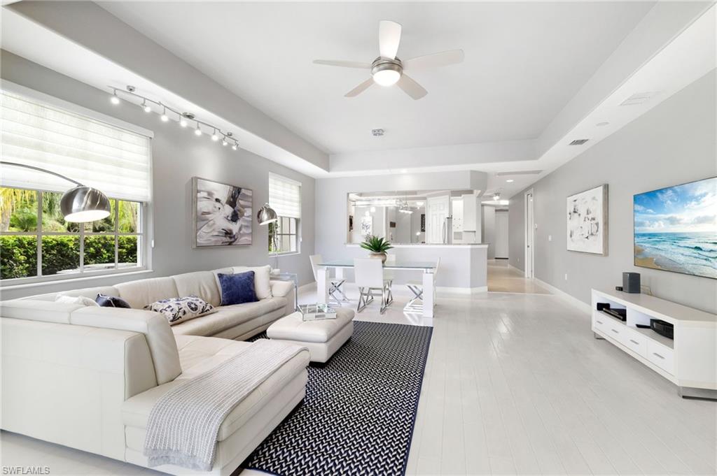 19670 Marino Lake Circle, Unit 2502 Miromar Lakes, FL 33913 - Photo 5 of 40 a living room with furniture and a flat screen tv