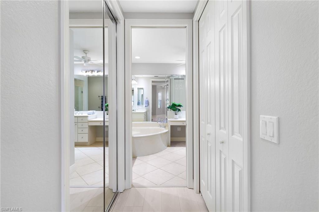 19670 Marino Lake Circle, Unit 2502 Miromar Lakes, FL 33913 - Photo 8 of 40 a bathroom with a glass shower door and a sink
