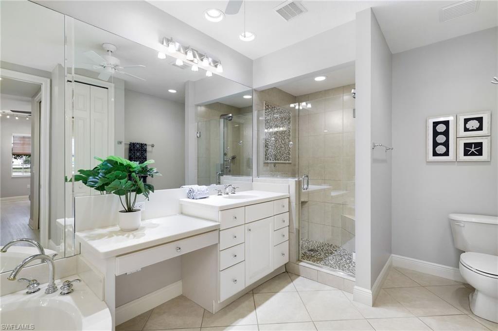 19670 Marino Lake Circle, Unit 2502 Miromar Lakes, FL 33913 - Photo 10 of 40 a bathroom with a sink toilet and shower