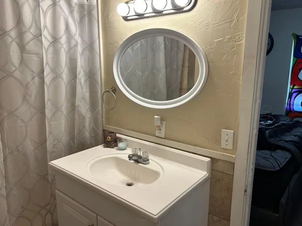 a bathroom with a sink and a mirror