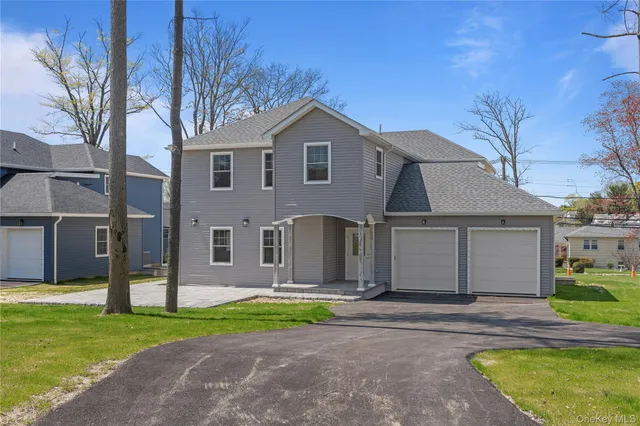 a front view of house with yard and green space