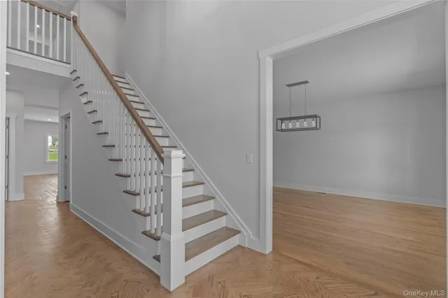 a view of entryway and hall with wooden floor