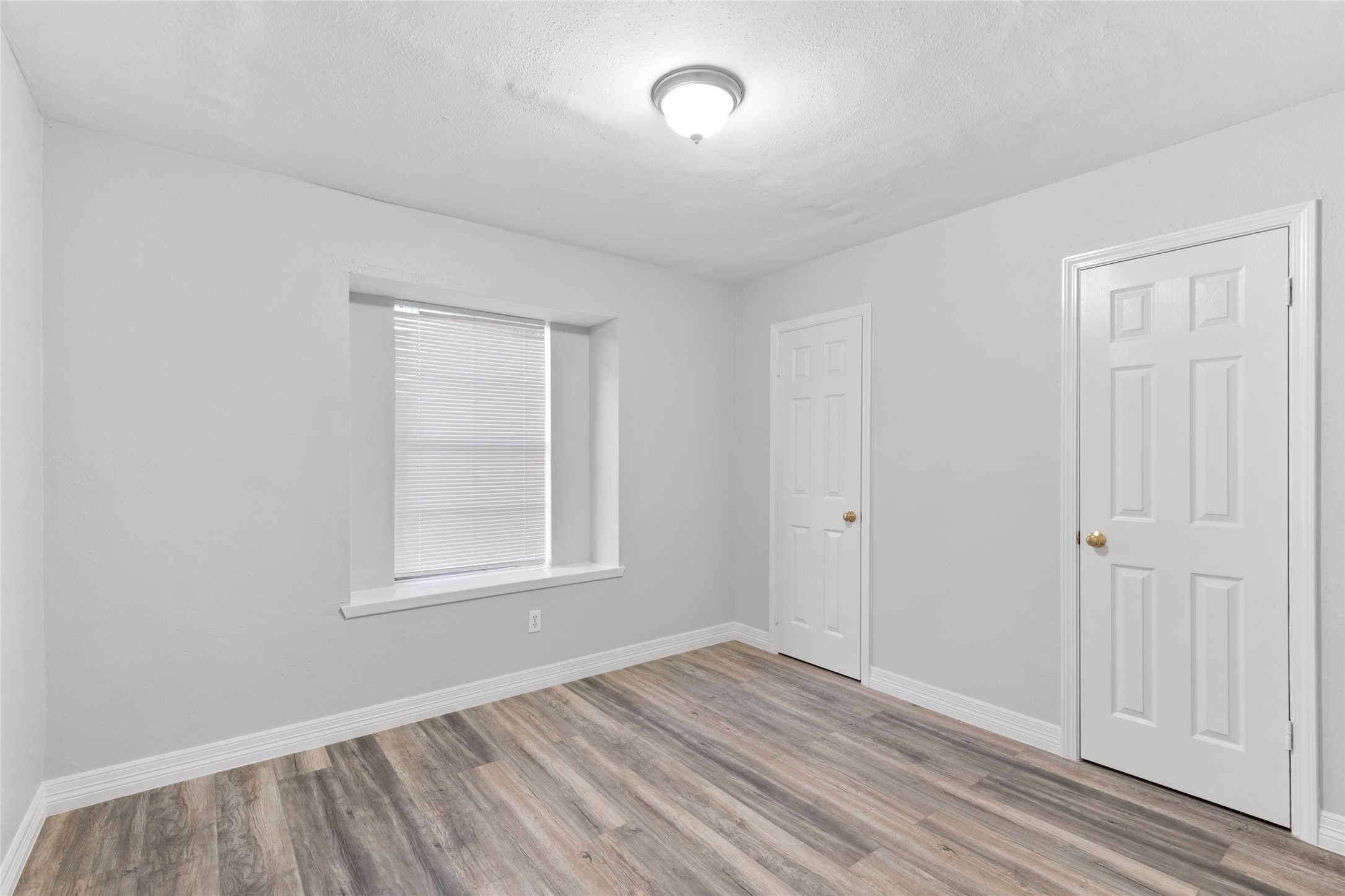 8314 Poplar Ridge Lane Humble, TX 77338 - Photo 13 of 20 an empty room with wooden floor and windows