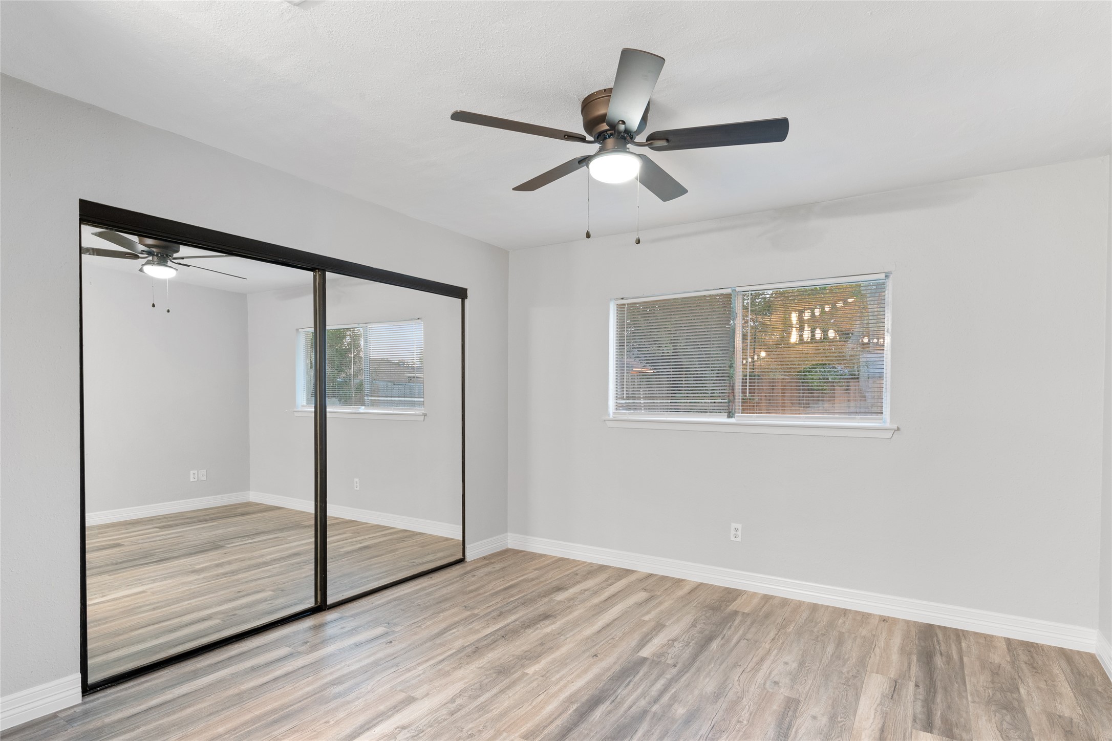 8314 Poplar Ridge Lane Humble, TX 77338 - Photo 14 of 20 a view of an empty room with wooden floor and a window
