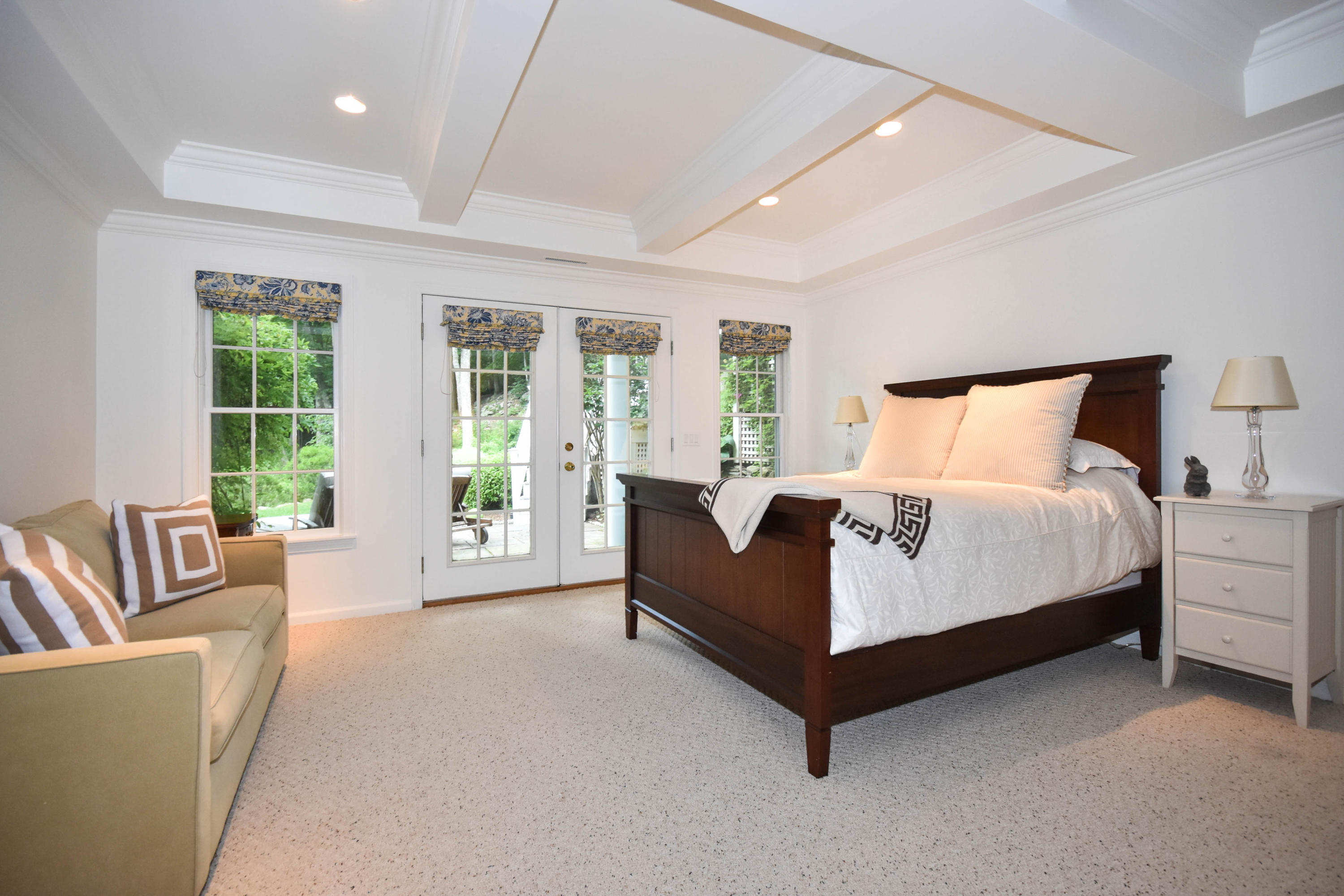 104 Jonathan Road New Canaan, CT 06840 - Photo 17 of 25 a spacious bedroom with a bed couch and a large window