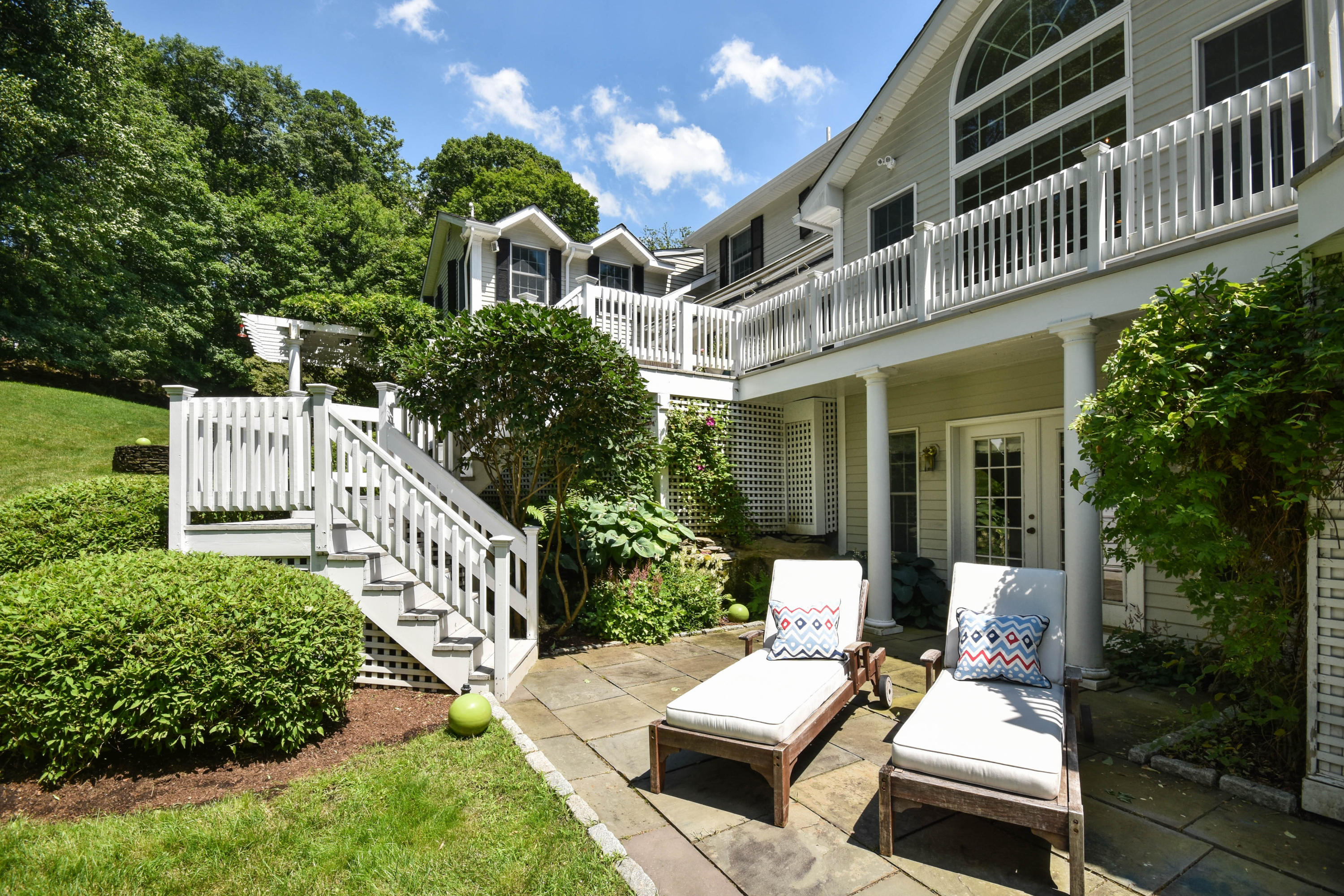 104 Jonathan Road New Canaan, CT 06840 - Photo 18 of 25 a view of a patio with couches table and chairs and potted plants