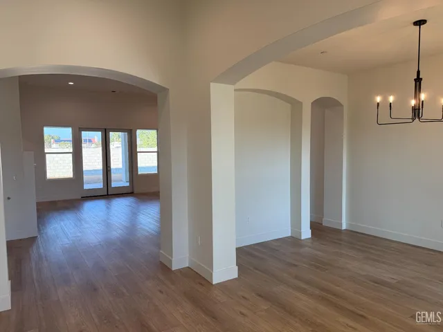 a view of a room with wooden floor and window