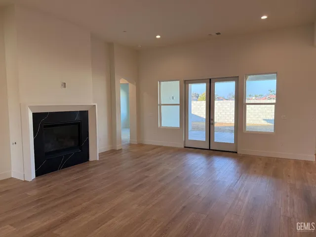 a view of an empty room with a fireplace and a window