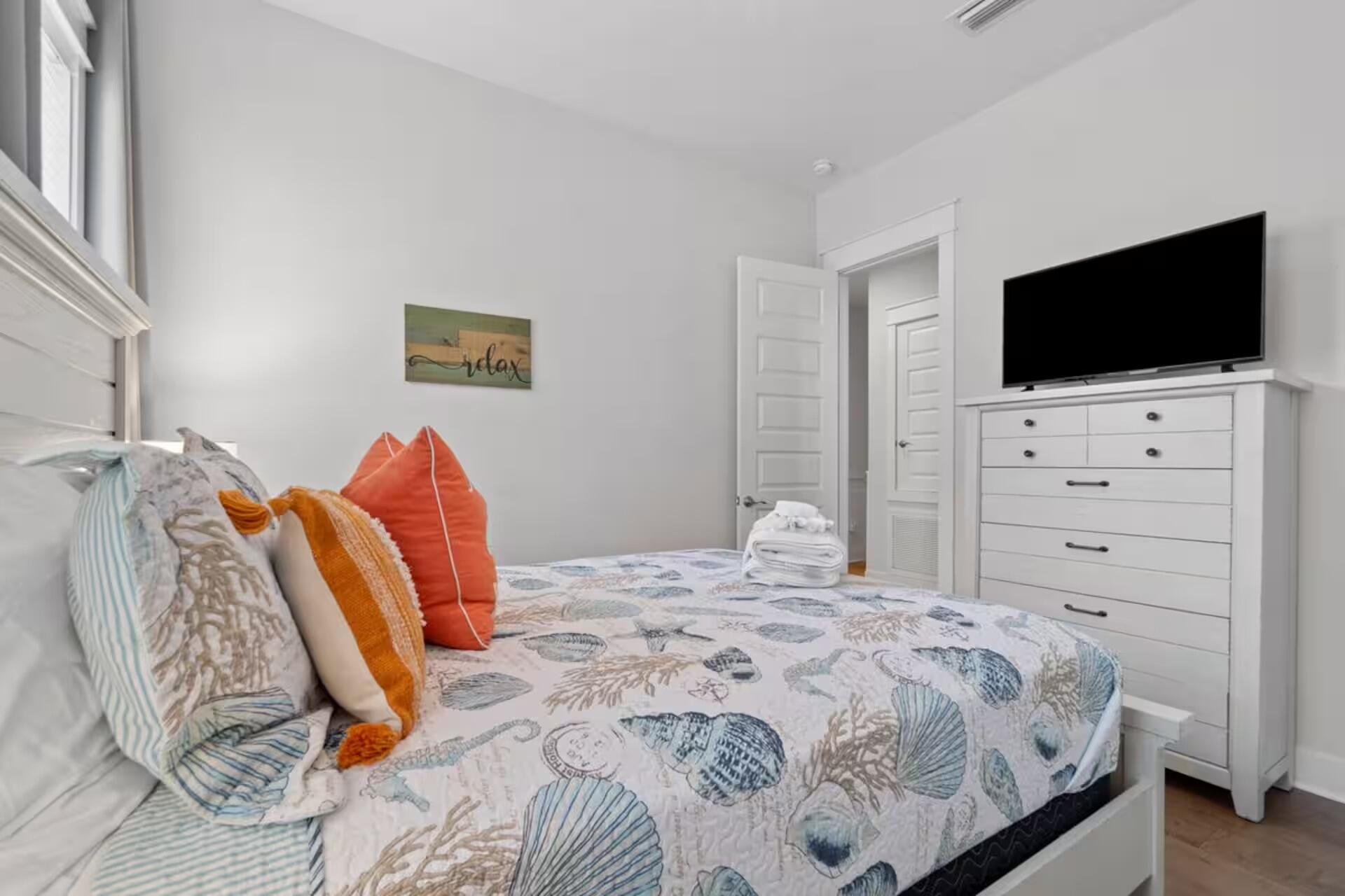 146 East E Pine, Unit B Inlet Beach, FL 32461 - Photo 27 of 47 a bedroom with a bed and a flat screen tv