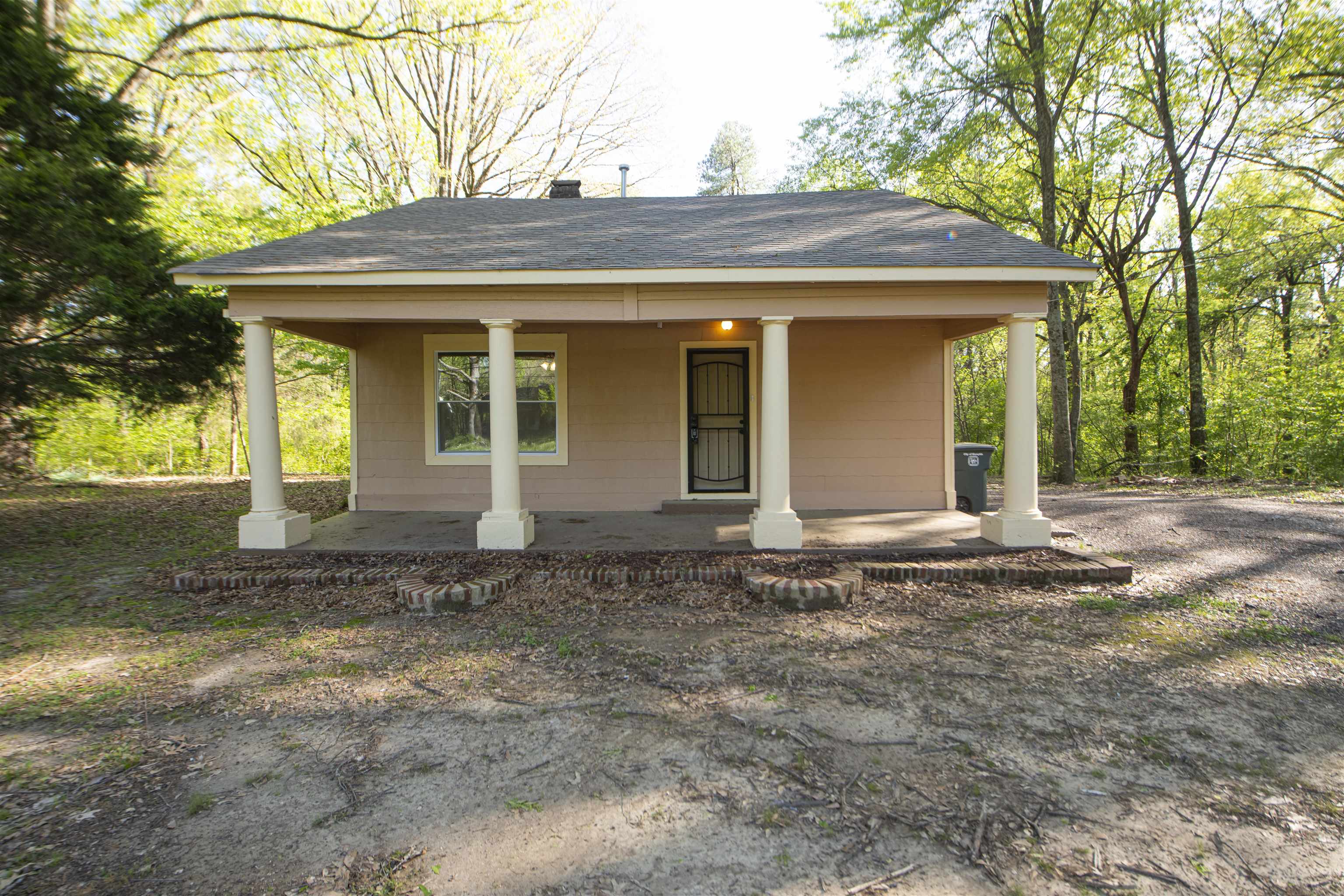 899 Craft Road Memphis, TN 38116 - Photo 1 of 13 View of front of house with a porch, a shingled roof, and a chimney
