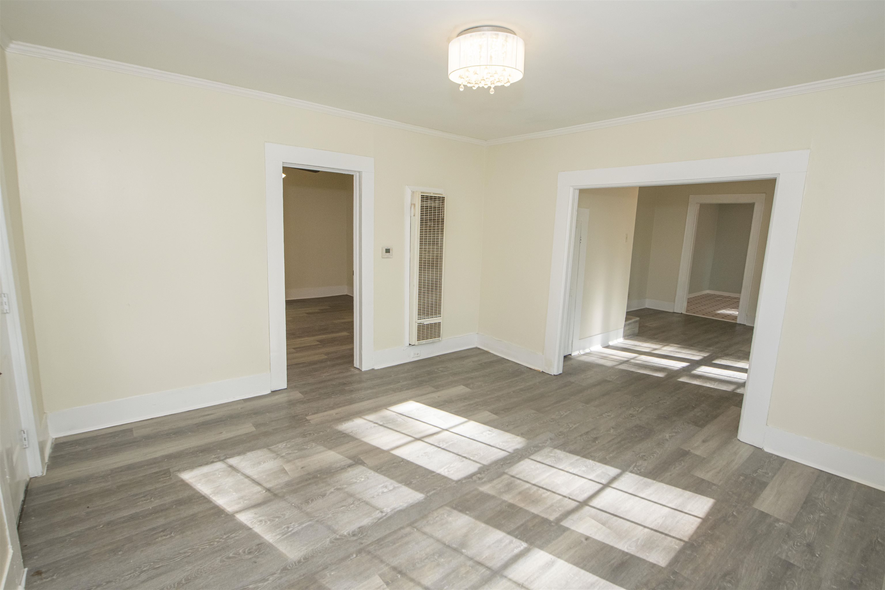 899 Craft Road Memphis, TN 38116 - Photo 11 of 13 Spare room featuring crown molding, an inviting chandelier, and baseboards