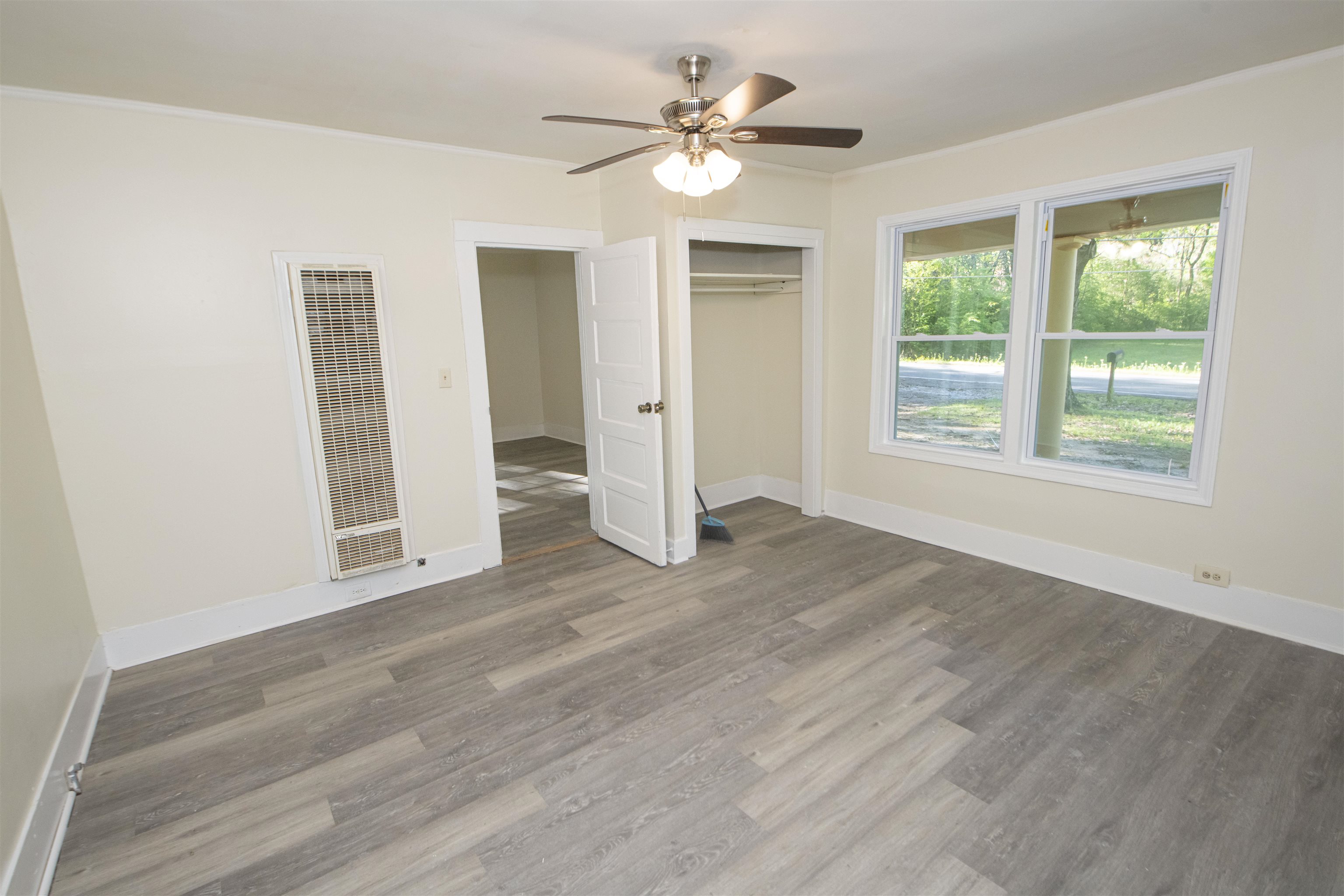 899 Craft Road Memphis, TN 38116 - Photo 12 of 13 Unfurnished bedroom with ornamental molding, baseboards, a heating unit, and wood finished floors