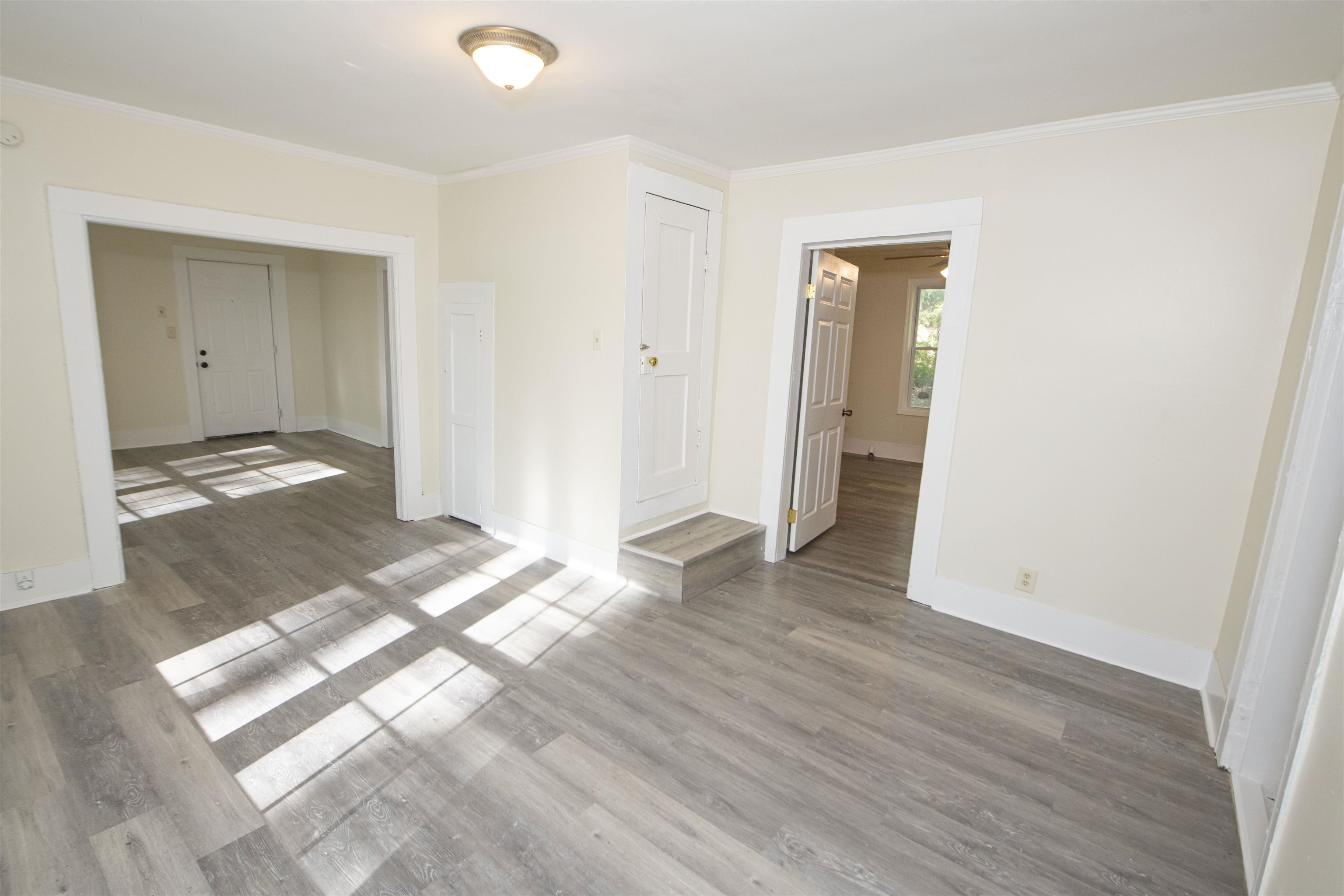 899 Craft Road Memphis, TN 38116 - Photo 3 of 13 Unfurnished room featuring wood finished floors, baseboards, and ornamental molding