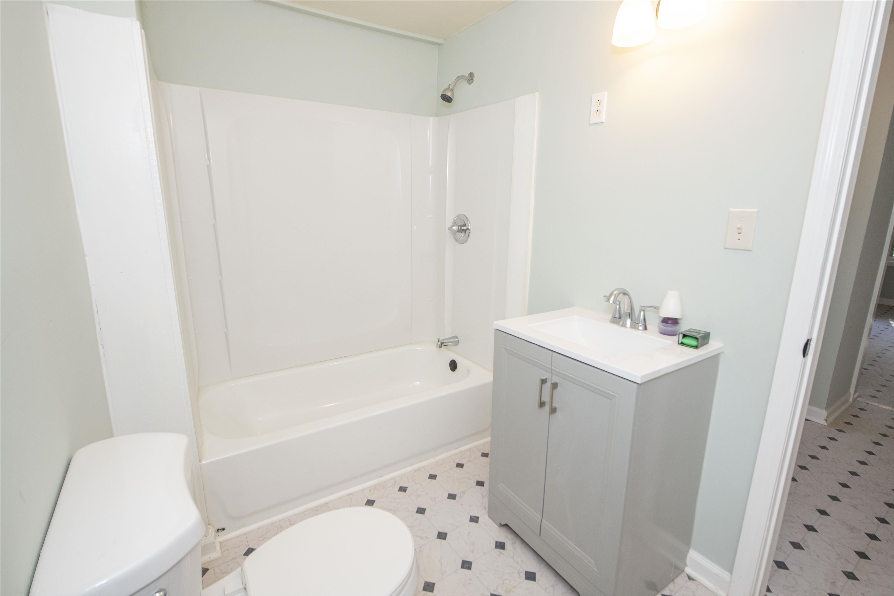 899 Craft Road Memphis, TN 38116 - Photo 7 of 13 Full bathroom with tile patterned floors, shower / bath combination, vanity, and toilet