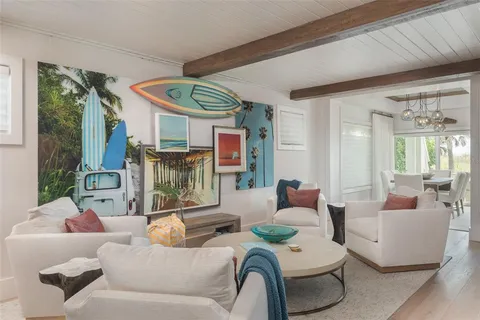 a living room with a flat screen tv and a floor to ceiling window