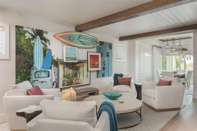 a living room with a flat screen tv and a floor to ceiling window