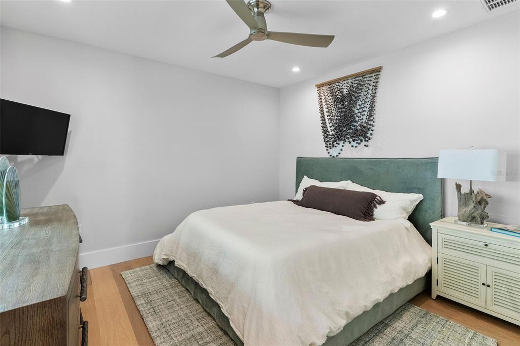 2807 Sunset Way St. Pete Beach, FL 33706 - Photo 23 of 49 a bedroom with a bed and a couch