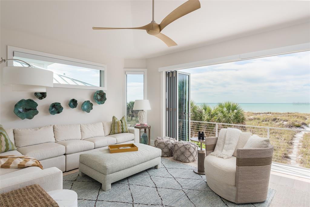 2807 Sunset Way St. Pete Beach, FL 33706 - Photo 28 of 49 a living room with furniture and a floor to ceiling window