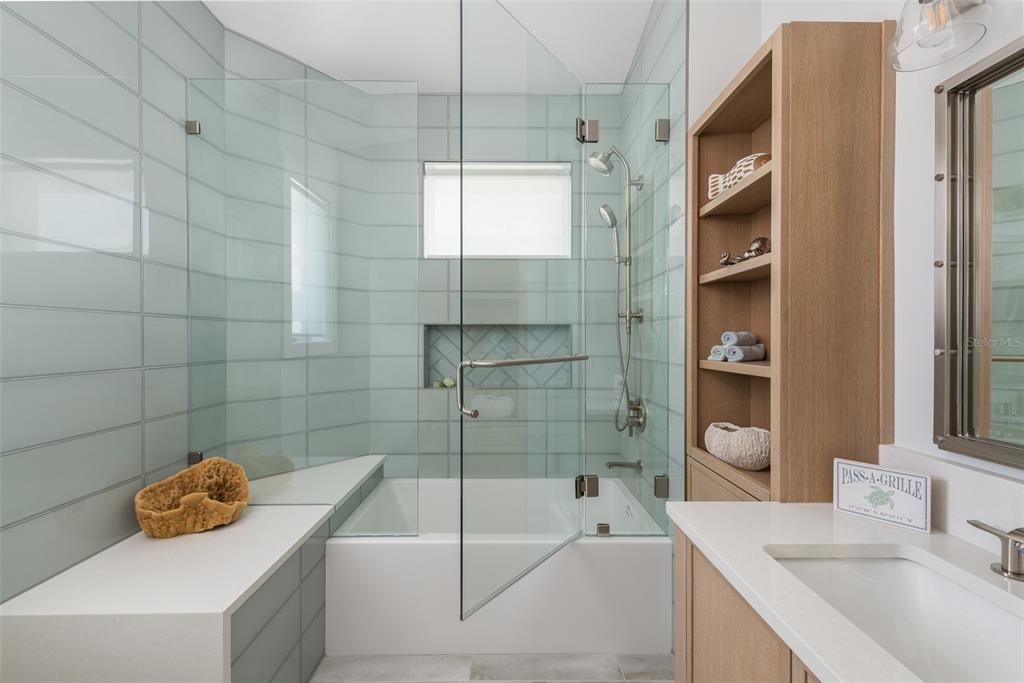 2807 Sunset Way St. Pete Beach, FL 33706 - Photo 32 of 49 a bathroom with a tub a sink and a shower