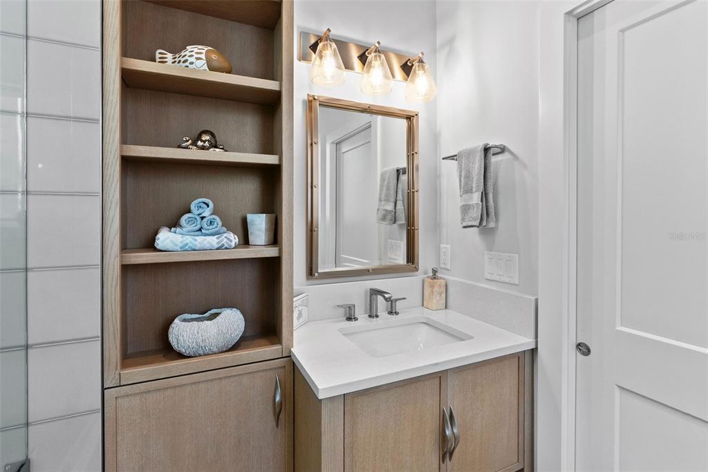 2807 Sunset Way St. Pete Beach, FL 33706 - Photo 33 of 49 a bathroom with a sink mirror and vanity