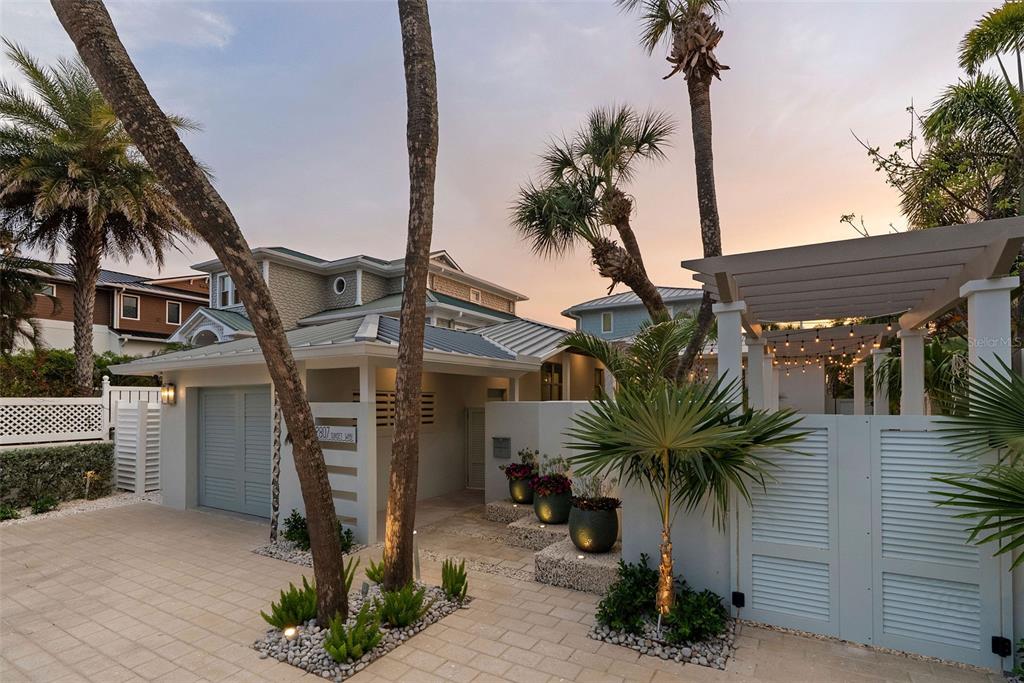 2807 Sunset Way St. Pete Beach, FL 33706 - Photo 48 of 49 a palm tree sitting in front of a house with a fountain