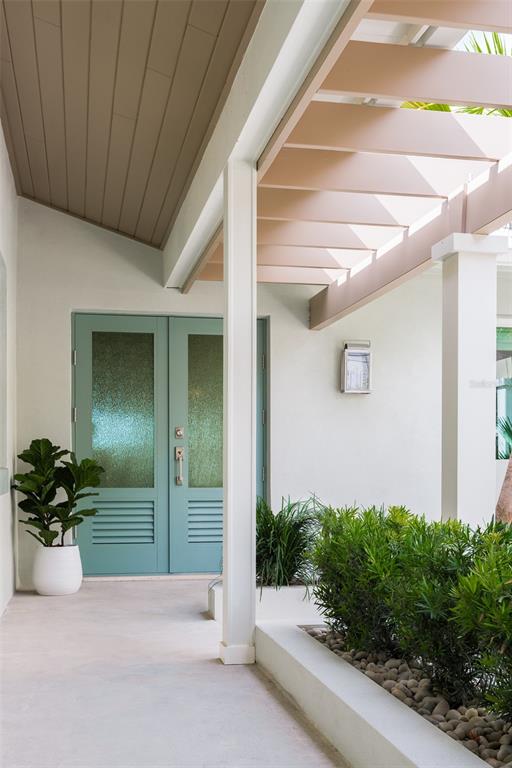 2807 Sunset Way St. Pete Beach, FL 33706 - Photo 7 of 49 a view of a entrance door of the house