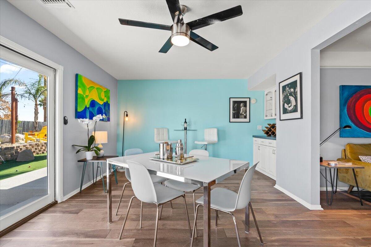 2236 North Victoria Road Palm Springs, CA 92262 - Photo 11 of 40 a view of a dining room with furniture window and wooden floor