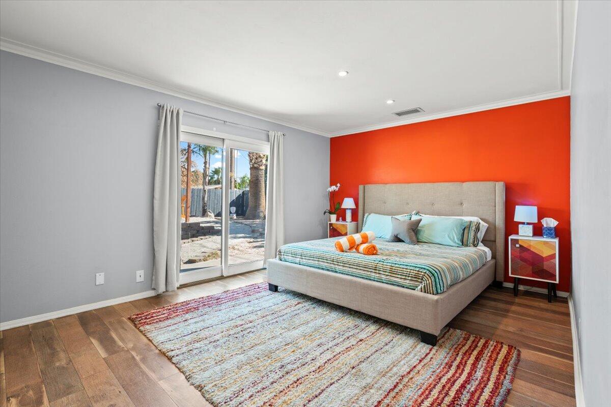 2236 North Victoria Road Palm Springs, CA 92262 - Photo 16 of 40 a bedroom with a bed and wooden floor