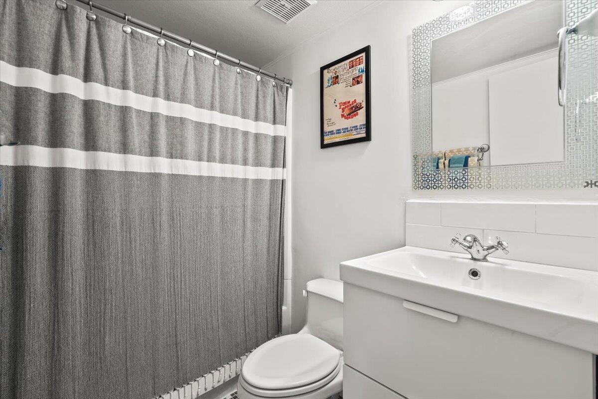 2236 North Victoria Road Palm Springs, CA 92262 - Photo 22 of 40 a bathroom with a sink a toilet and shower curtain