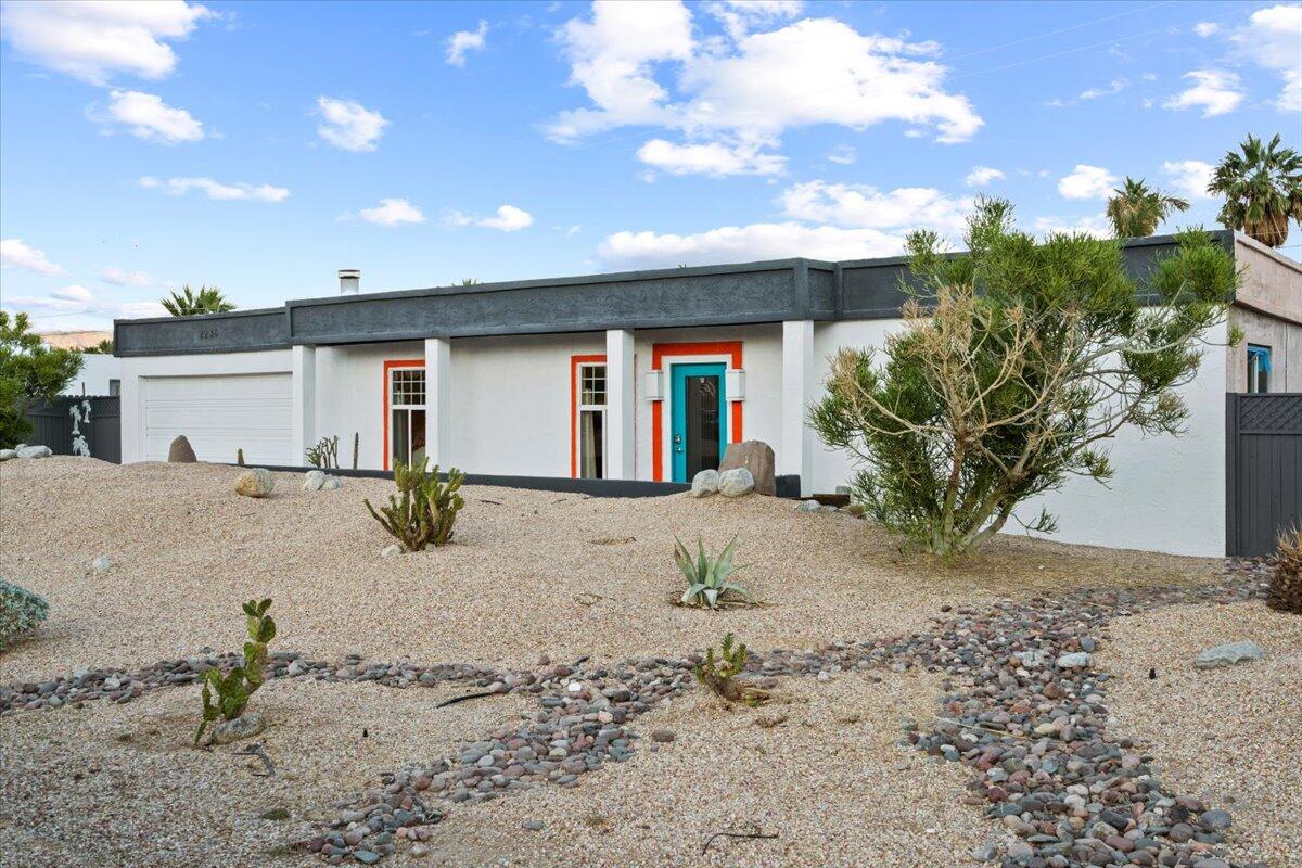 2236 North Victoria Road Palm Springs, CA 92262 - Photo 27 of 40 a front view of a house with a yard and a garage