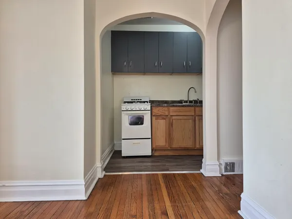 a kitchen with granite countertop a stove and a sink