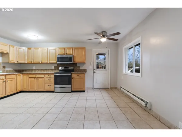 a kitchen with stainless steel appliances granite countertop a stove cabinets and a refrigerator