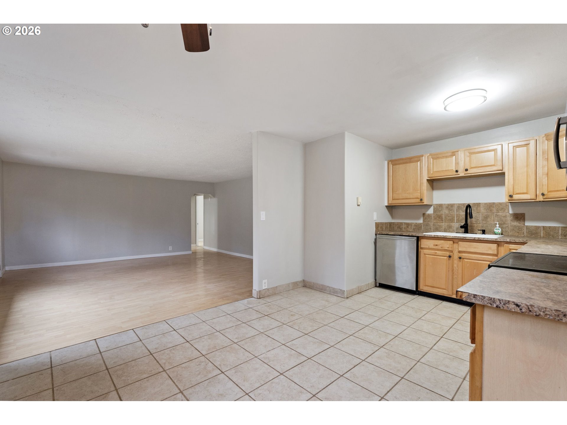 25106 Northeast 25th Street Camas, WA 98607 - Photo 13 of 47 a kitchen with granite countertop a sink cabinets and stainless steel appliances