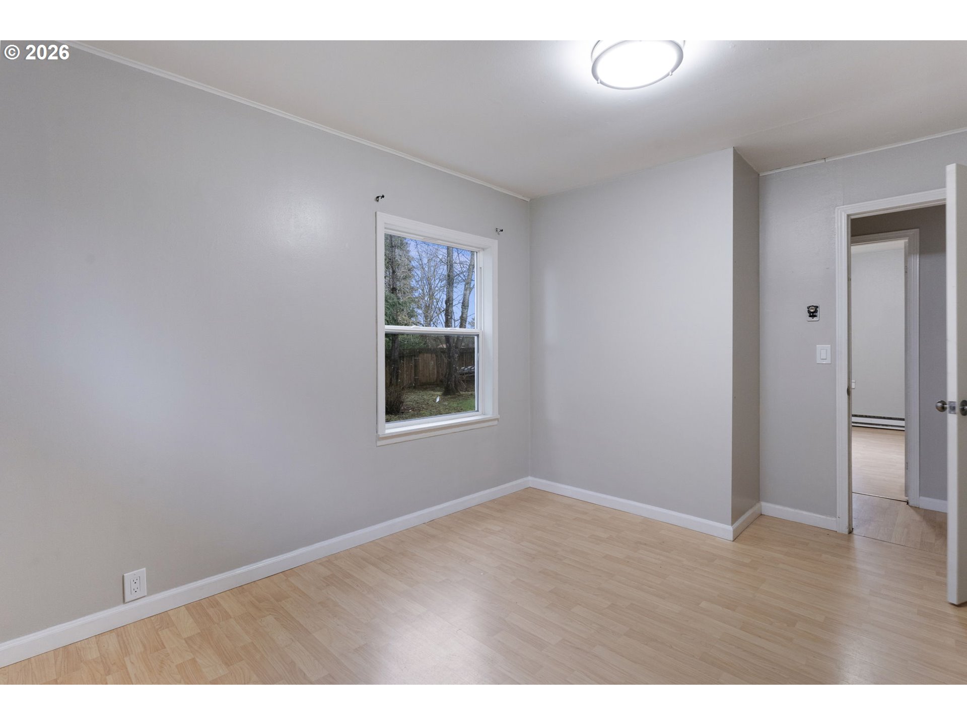 25106 Northeast 25th Street Camas, WA 98607 - Photo 15 of 47 a view of an empty room with wooden floor and a window