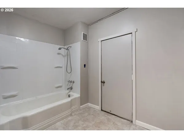 a bathroom with a bathtub and a shower
