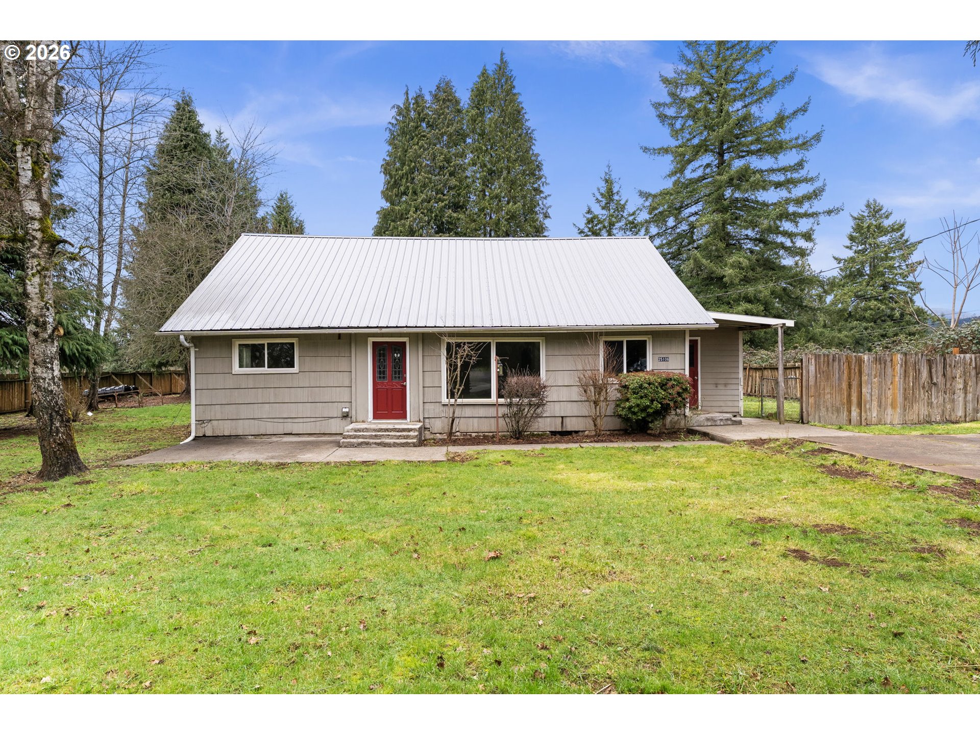 25106 Northeast 25th Street Camas, WA 98607 - Photo 46 of 47 a front view of a house with a garden and trees