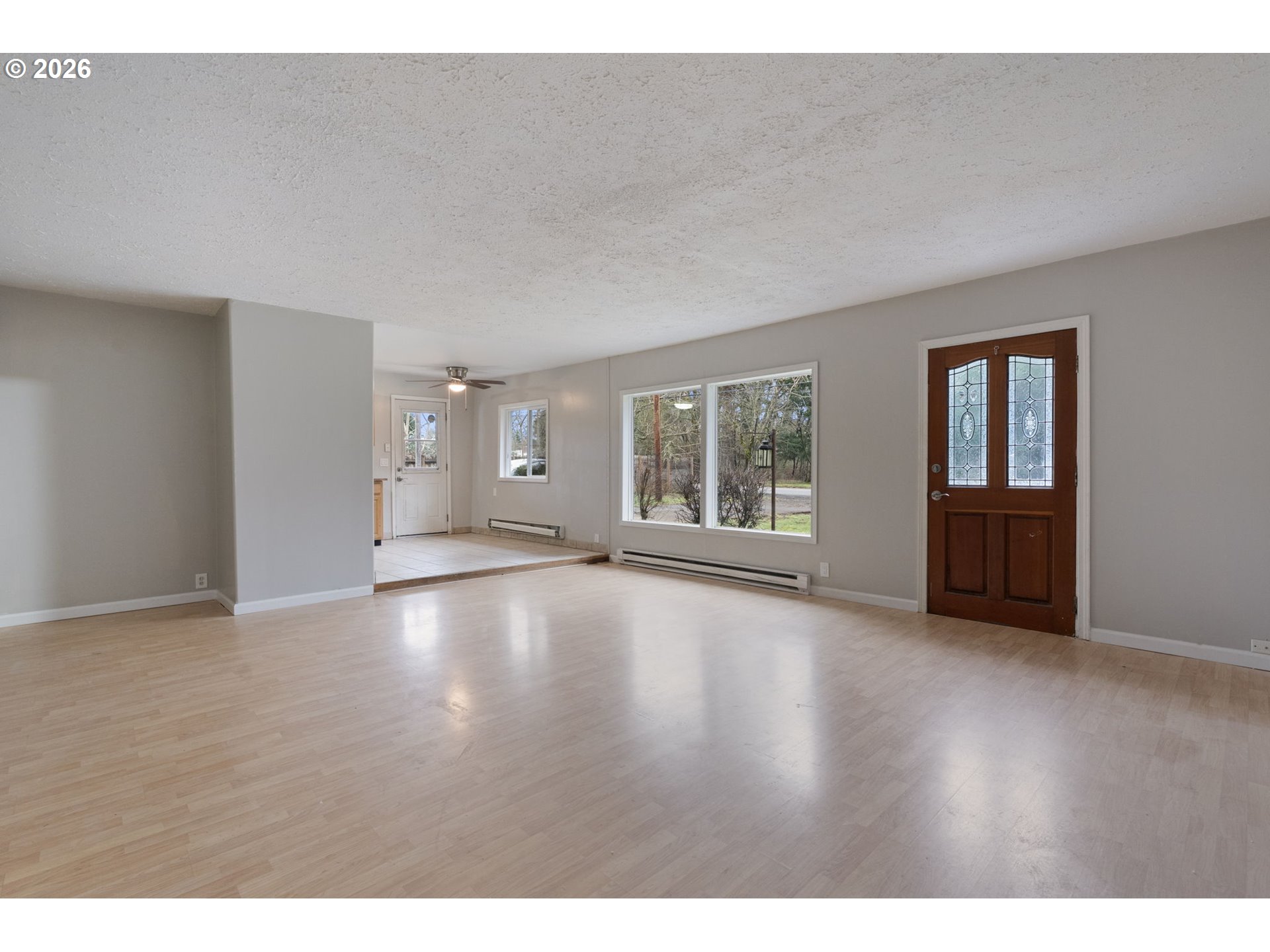 25106 Northeast 25th Street Camas, WA 98607 - Photo 5 of 47 a view of an empty room with wooden floor and windows